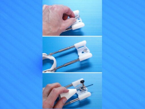These three still frames show placement of the SGX clip into the yoke of the extender and hooking the tugging rod through the clip and securing the rod with a collar and set screw.